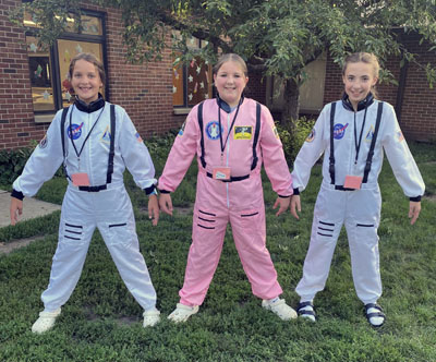 teen helpers dressed as astronauts