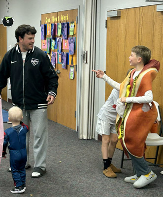 man talking to a very large hotdog