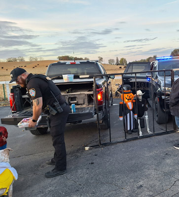 pumpkin man and skeleton behind bars