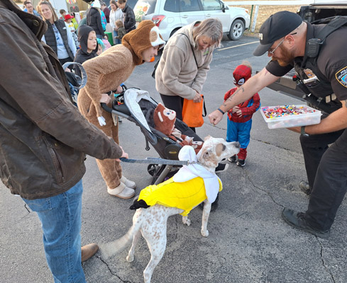 sheriff offers fist-bump to a baby